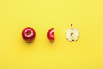 Fresh red apple with different pieces on color background