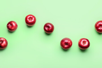 Fresh red apples on color background