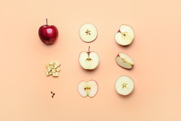 Fresh red apple with different pieces and seeds on color background
