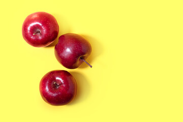Fresh red apples on color background
