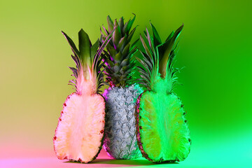 Toned fresh pineapples on color background