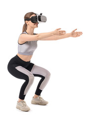 Sporty young woman with virtual reality glasses training on white background