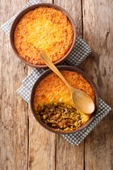 Corn and Beef Chilean Pastel de Choclo closeup in the bowl on the table. Vertical top view from above