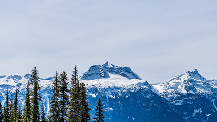 Fototapeta na wymiar Beautiful snow-capped Columbia Mountains against the blue sky in British Columbia Canada