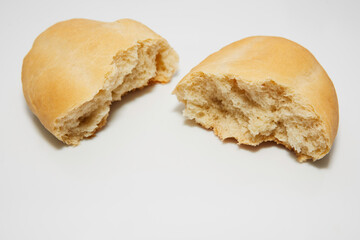 Bread cut in half, thus showing its flour dough filling