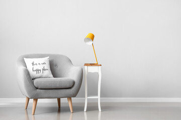 Interior of modern room with armchair and lamp