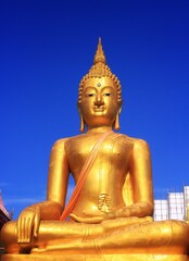 golden buddha statue and blue sky