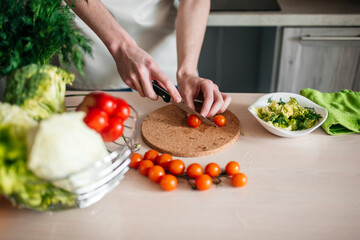 male hands chopping salad and onion, cooking healthy food in the kitchen.