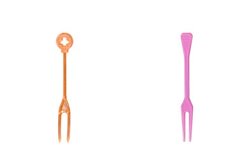 Orange and pink plastic forks isolated on white background
