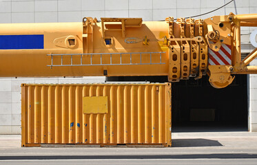 Part of a large mobile crane and a container