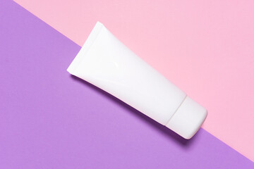 Creative beauty fashion concept photo of cosmetic recyclable bottle lotion cream on purple pink background.