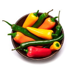 Wooden bowl full of Chili or sweet peppers isolated on white background