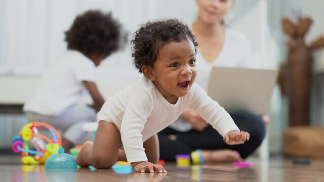 Happy African American Little baby boy crawling and looking for something to learn
