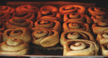 Cinnamon rolls are baked in oven, homemade cakes.