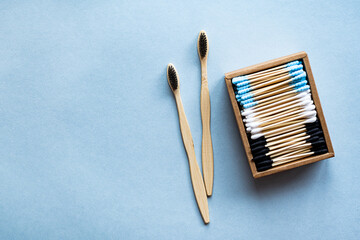 Colored bamboo toothbrushes and cotton swabs. The modern concept of zero waste body care products. Eco friendly or sustainable lifestyle.