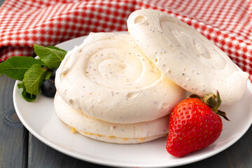 White meringue cake on plate served on table