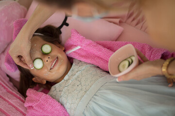 Obraz na płótnie Canvas Little girl having a treatment for face.