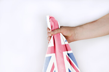 Light national flag of Great Britain in hand against a white background.