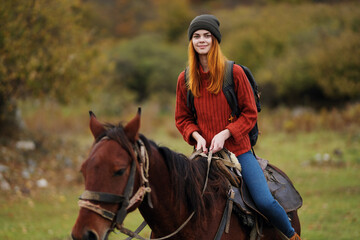 cheerful woman hiker ride a horse fun travel mountains