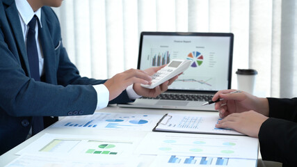 Business concept a couple of business partners calculating annual income and expense for creating the next financial plan.