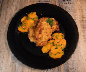 Recipe for breaded chicken cutlet, glazed carrots. High quality photo