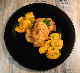 Recipe for breaded chicken cutlet, glazed carrots. High quality photo