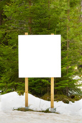 white advert billboard placeholder, blank information poster in forest. white empty Bulletin board in winter pine forest for outdoor info banner. mockup