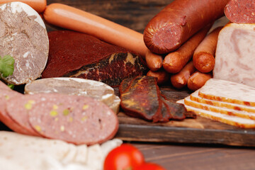 Assortment of meat and sausage on wooden surface
