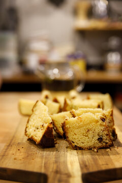 fragrant freshly baked cupcake with raisins sliced into pieces on a wooden board. High quality photo