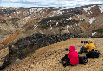  Photographers in volcanic mountains of Landmannalaugar in Fjallabak Nature Reserve. Iceland