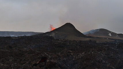 Stunning view of erupting volcano ejecting hot lava in Geldingadalir valley near Fagradalsfjall...