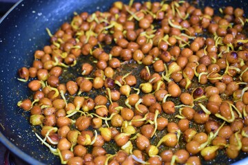 cooking sprouted chickpea beans in a pan closeup