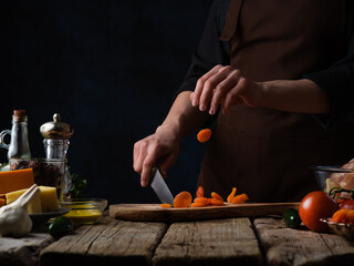 The chef prepares slicing dried apricots for cooking. Culinary recipes