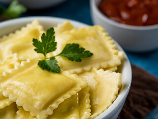 Homemade ravioli or dumplings with sauce and ketchup on a blue table. Recipes