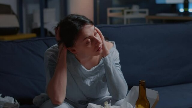 Lonely unhappy, depressed, frustrated woman sitting on couch with head on hends feeling disappointed, suffering from insomnia, stress anxiety, mental problems, suicidal thoughts, chronic disease