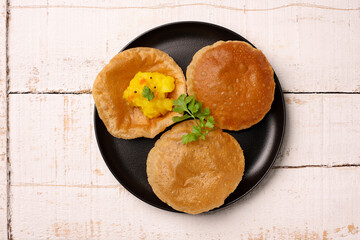 Puri Bhaji North Indian Poori with aalu bhaji , aalu sabji potato spicy recipe breakfast food a deep fried bread of whole wheat flour. poori masala in restaurant Kerala, India, Sri Lanka.