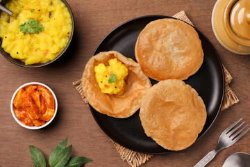 Puri Bhaji North Indian Poori with aalu bhaji , aalu sabji potato spicy recipe breakfast food a deep fried bread of whole wheat flour. poori masala in restaurant Kerala, India, Sri Lanka.