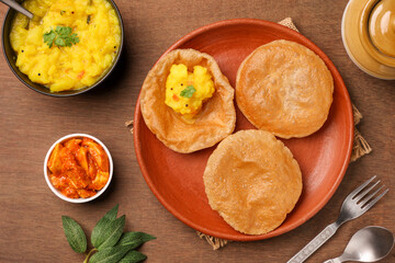 Puri Bhaji North Indian Poori with aalu bhaji , aalu sabji potato spicy recipe breakfast food a deep fried bread of whole wheat flour. poori masala in restaurant Kerala, India, Sri Lanka.