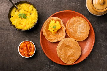 Puri Bhaji North Indian Poori with aalu bhaji , aalu sabji potato spicy recipe breakfast food a deep fried bread of whole wheat flour. poori masala in restaurant Kerala, India, Sri Lanka.