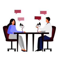 2 people are having conversation via microphone white sitting at the opposite side of table