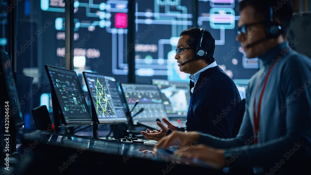 Aufkleber Portrait of Professional IT Technical Support Specialist Working on Computer in Monitoring Control Room with Digital Screens. Employee Wears Headphones with Mic and Talking on a Call.