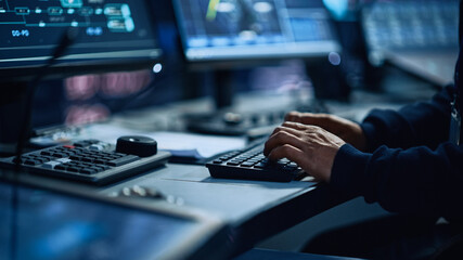 Close Up of a Professional Office Specialist Working on Desktop Computer in Modern Technological Monitoring Control Room with Digital Screens. Manager Typing on keyboard and Using Mouse. - Powered by Adobe