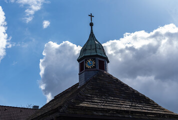 Old church and striking clock in sunshine in Germany