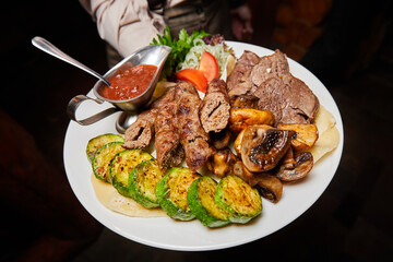 Beef lula kebab and shish kebab with grilled vegetables. Close-up, selective focus