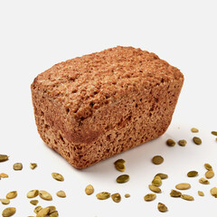 small rye bread on a white plate  pumpkin seeds