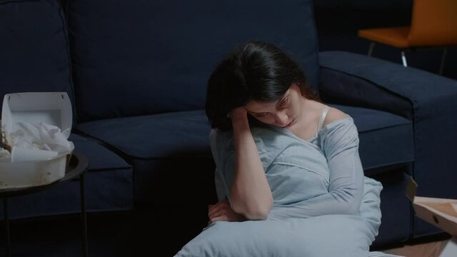 Traumatized shocked tierd unhappy woman sitting on floor thinking at problems, suffering from anxiety chronic disease insomnia mental problems suicidal thoughts feeling pain frustration disappointment