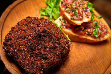 Veal steak breaded with spices with tomato salsa