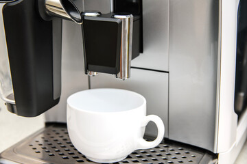 White coffee cup in coffee machine with cappuccino machine. Morning coffee