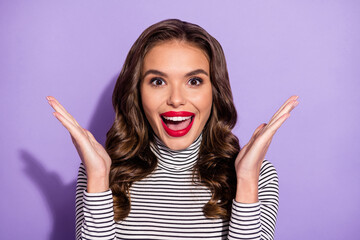 Close-up portrait of attractive cheerful lucky wavy-haired girl applauding having fun isolated over bright violet purple color background