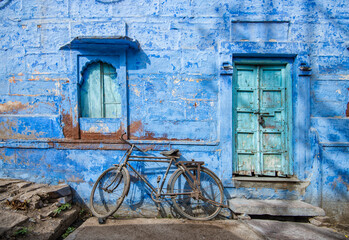 Bicycle against house in blue city, Jodhpur India.
